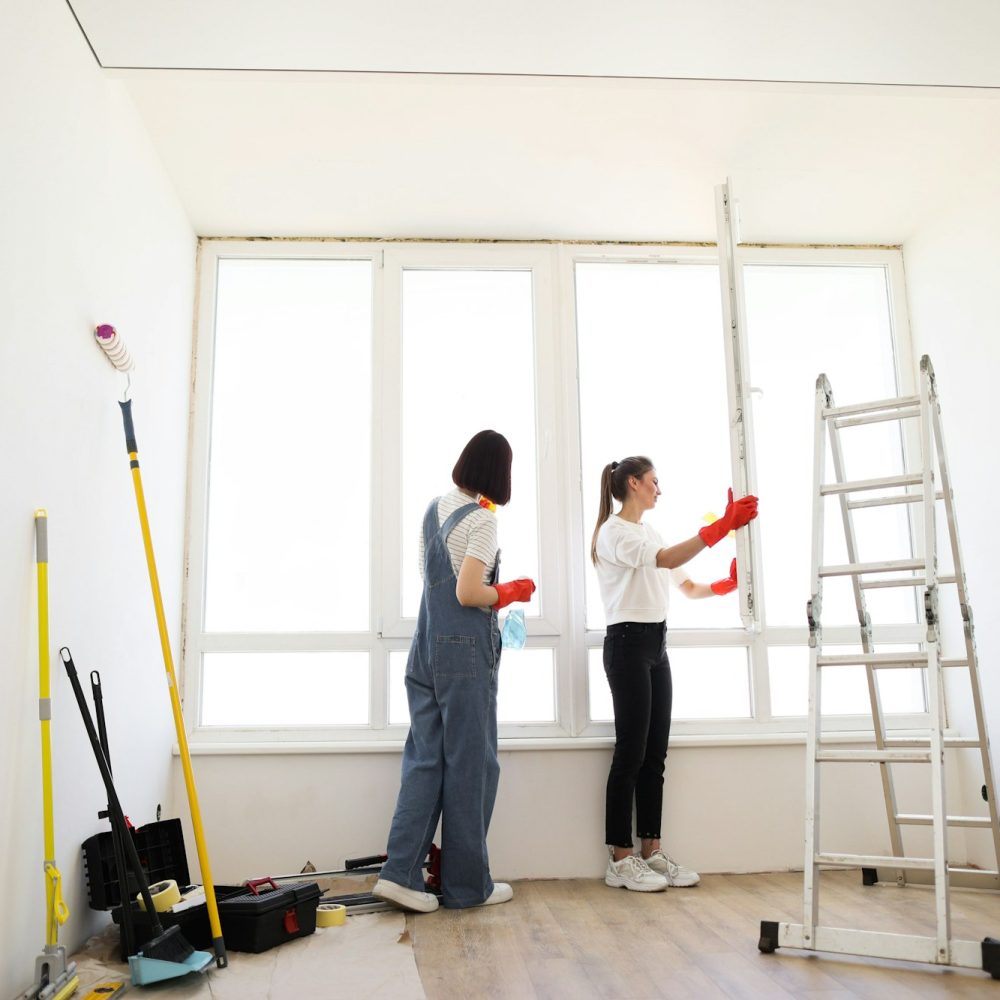 Attractive caucasian girls making house cleaning after repair. Attractive caucasian girls making house cleaning after repair.